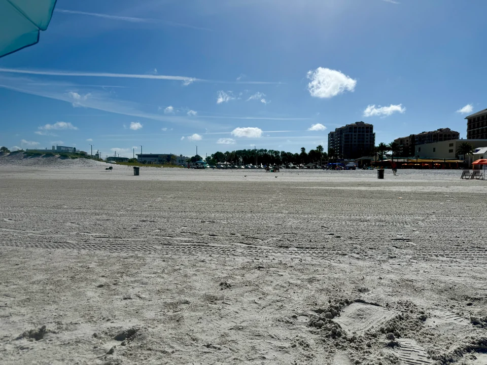 Wide sandy Clearwater Beach looking inland toward beachfront restaurants and hotels