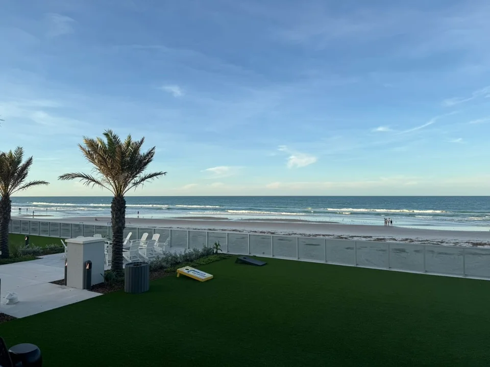 Palm trees and Daytona Beach’s Atlantic shoreline viewed from a beachfront terrace