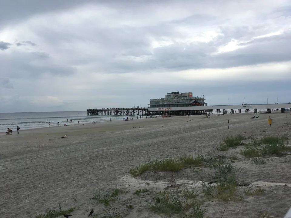 Daytona Beach Pier extending over the Atlantic beside a broad sandy beach