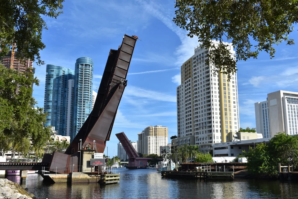 Raised drawbridge, boats and waterfront buildings on Fort Lauderdale’s New River