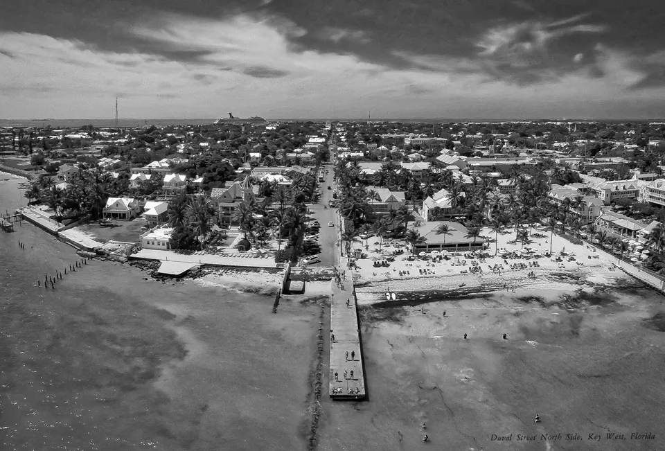 Black-and-white aerial view looking along Duval Street into Key West Old Town
