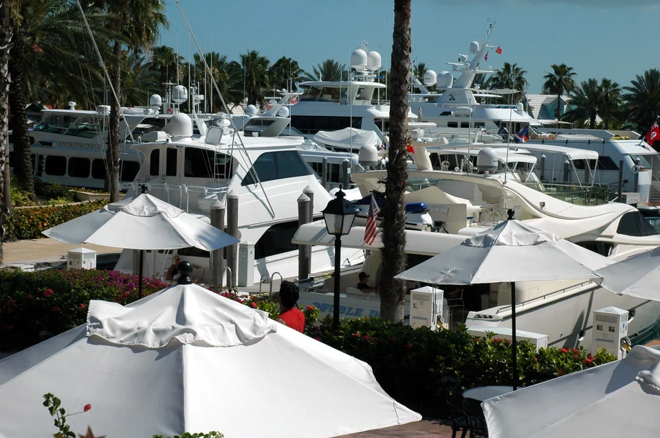 Yachts docked among palm trees at Atlantis Marina on Paradise Island