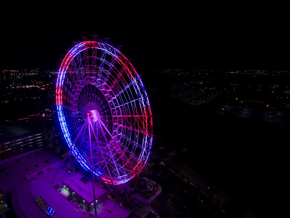 Orlando Eye observation wheel illuminated at night, viewed from above