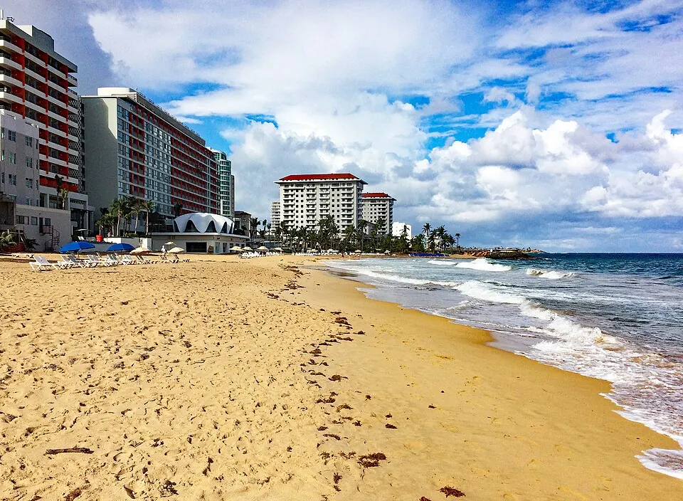 Condado Beach · San Juan — A portion of the Condado beach, with La Concha Hotel at left and Vanderbilt Hotel in distance, San Juan, Puerto Rico.