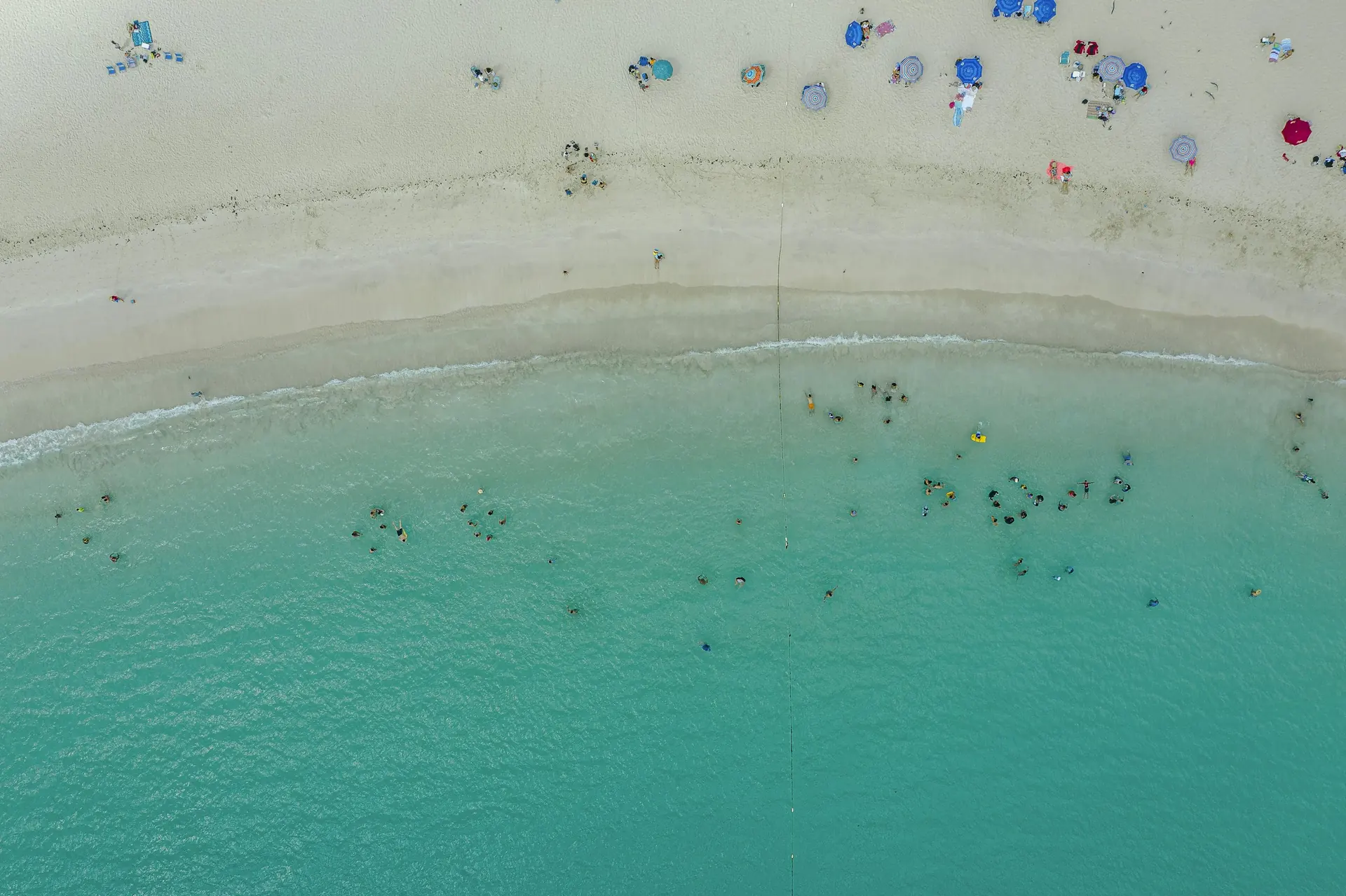 Aerial view of the sand and turquoise shoreline at Flamenco Beach