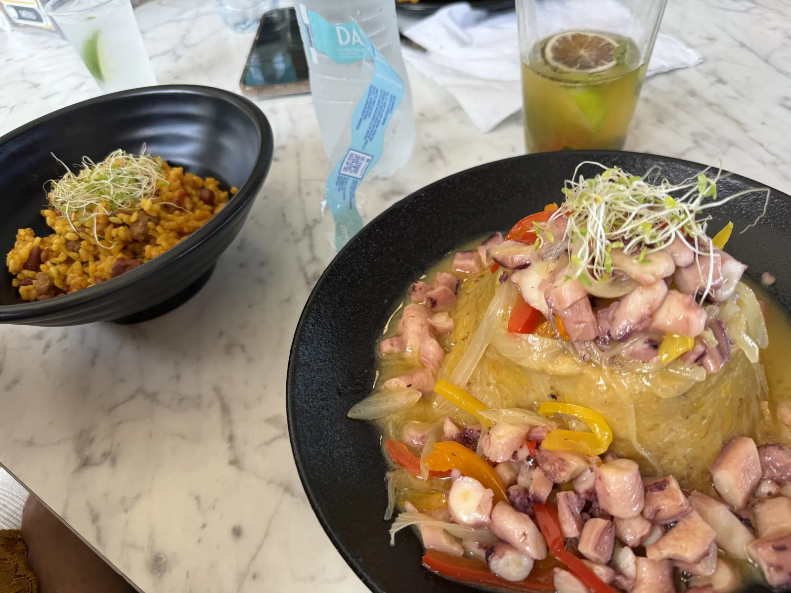Personal photograph of mofongo con pulpo and a side dish during a Naranjito meal