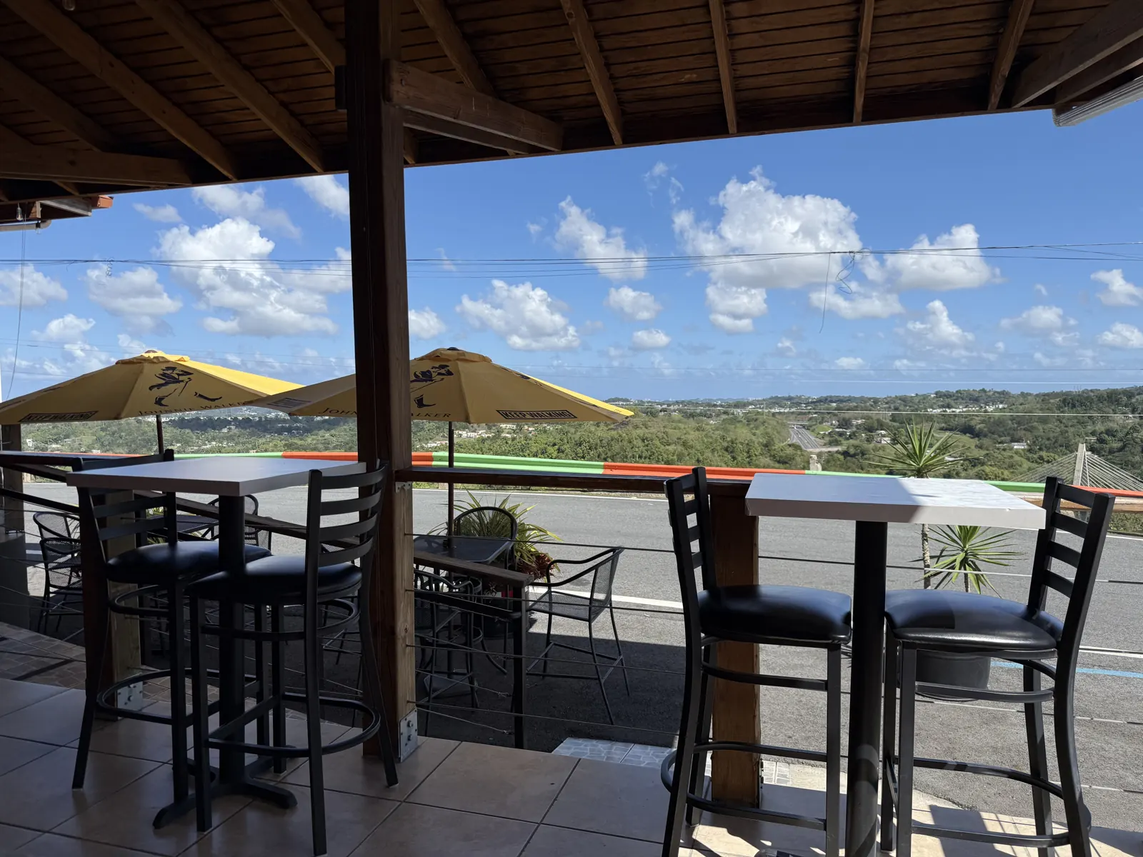 Personal photograph of Deleite en la Montaña’s covered dining terrace overlooking Naranjito hills
