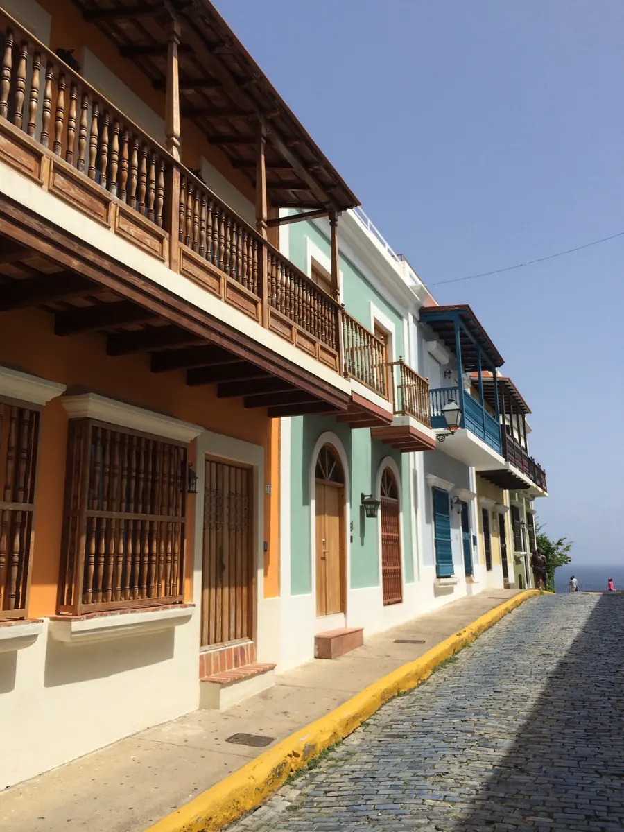 Wooden balconies and colorful façades along an Old San Juan street