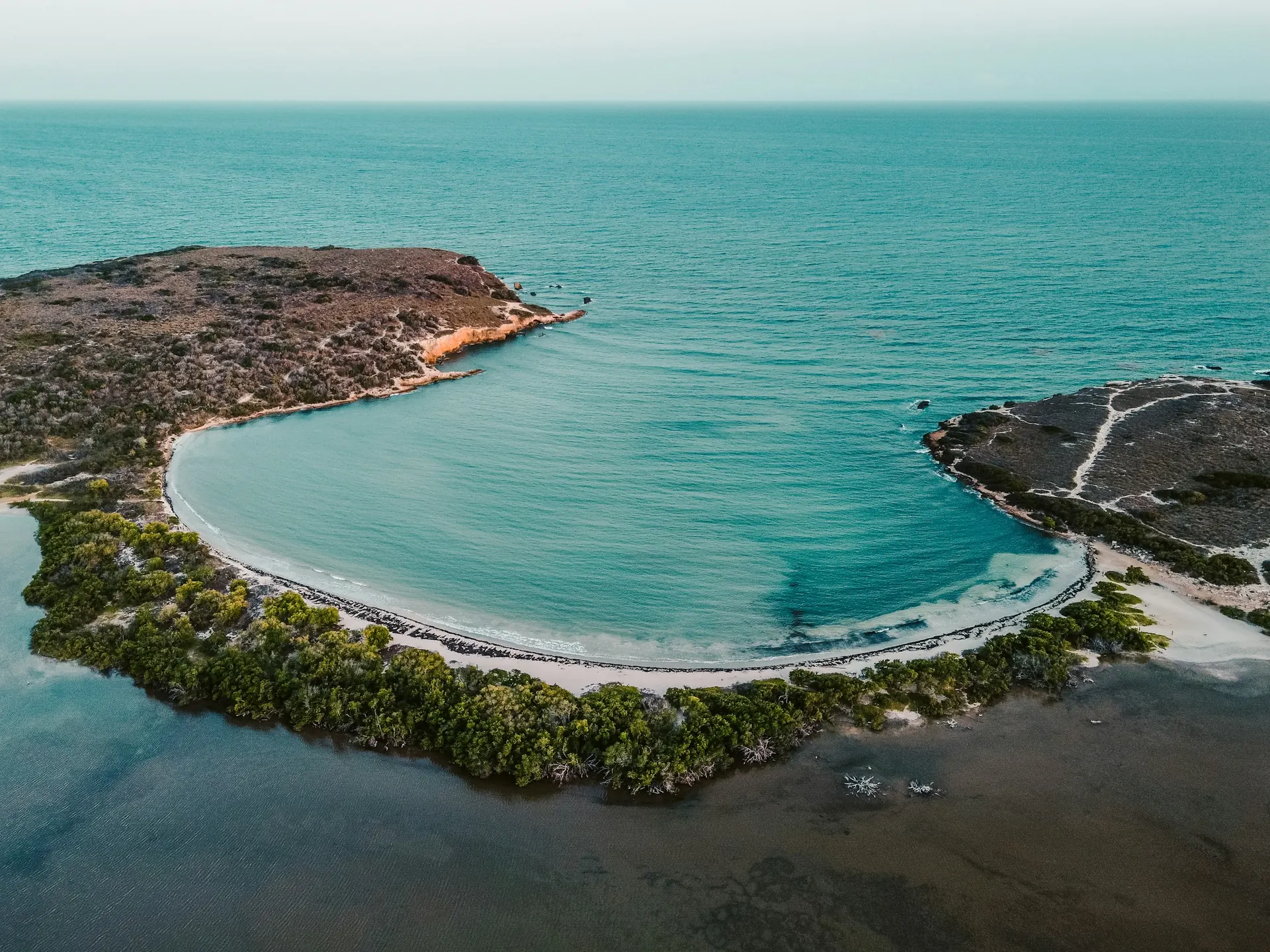 Aerial view of the curved Playa Sucia shoreline and Cabo Rojo peninsula