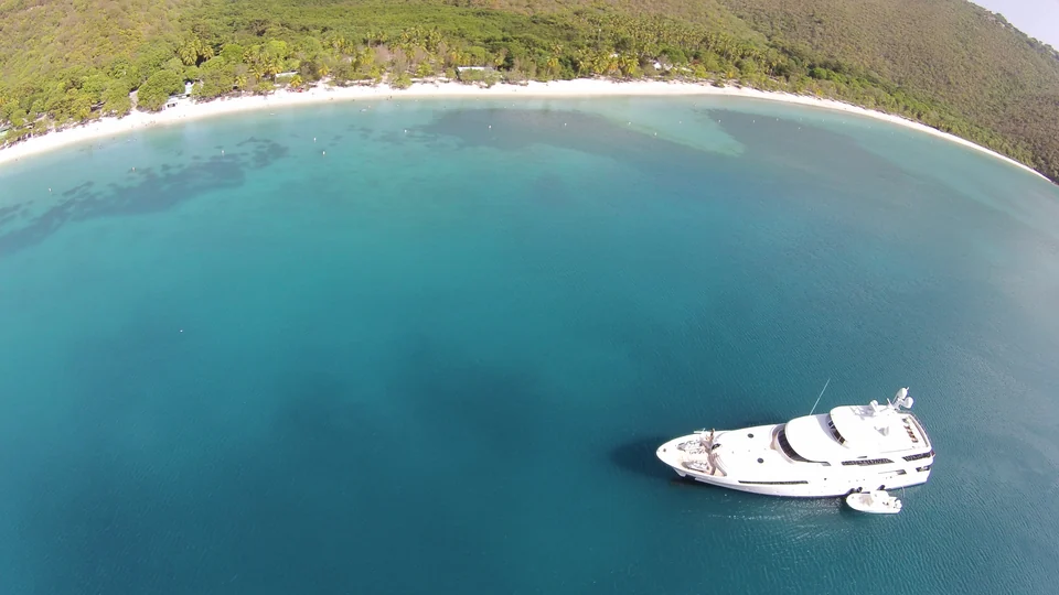 Elevated view of the curving white-sand shore and turquoise water of Magens Bay