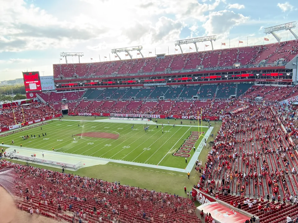 Football field and red stadium seating viewed from the stands at Raymond James Stadium